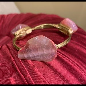 Gold bracelet with pink stones.